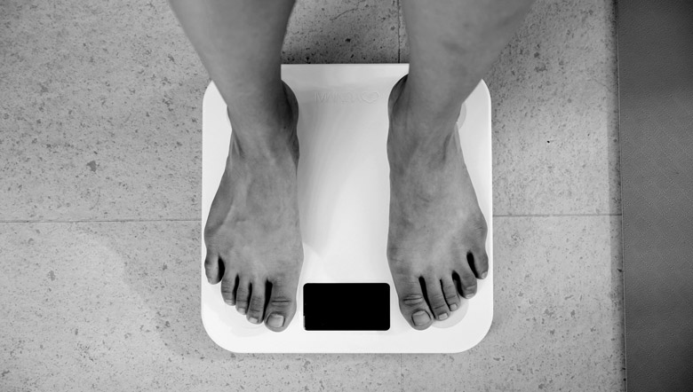Feet standing on a bathroom scale