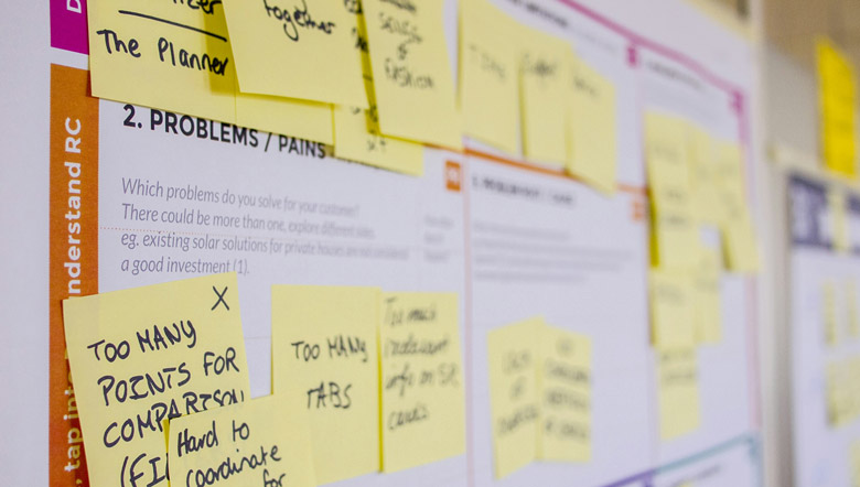 post-it notes with feedback on a whiteboard